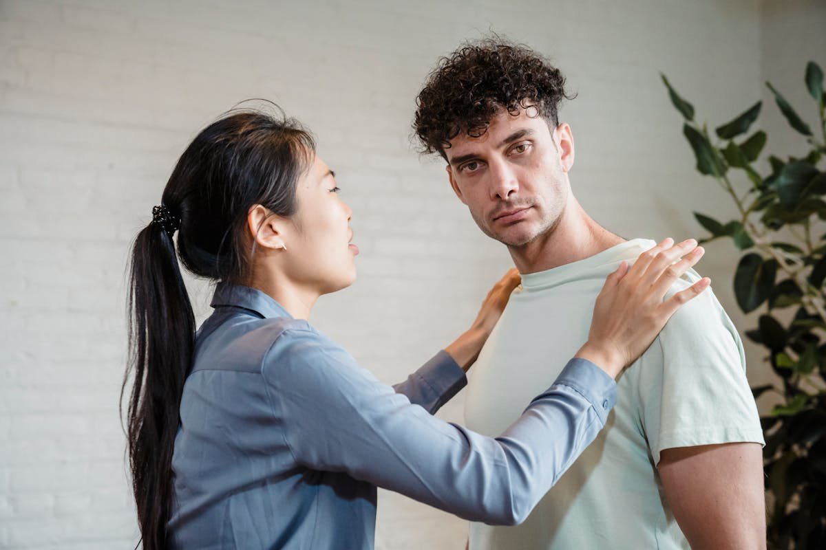 fitness trainer helping beginner with proper workout form