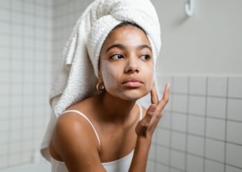 Woman applying gel sunscreen on oily skin with lightweight non-greasy texture